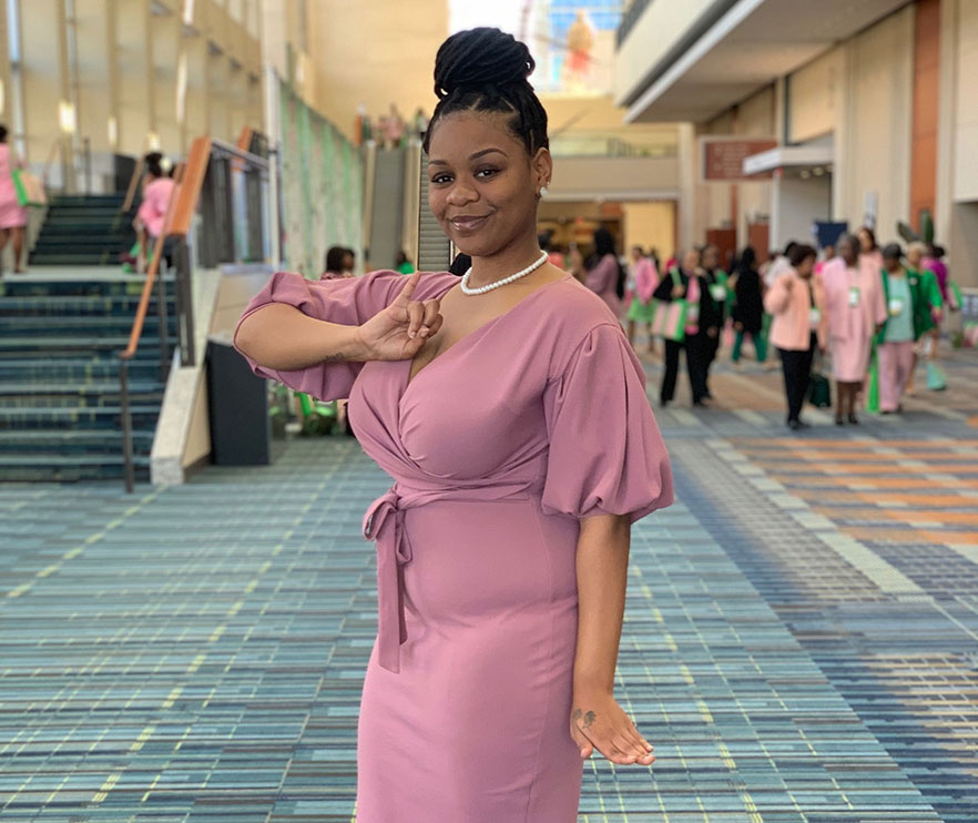 Cherika Marks stands at convention center with staircase in background