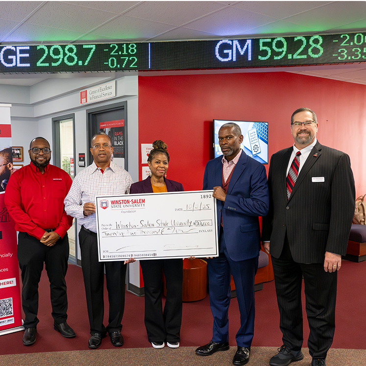alumni holding check